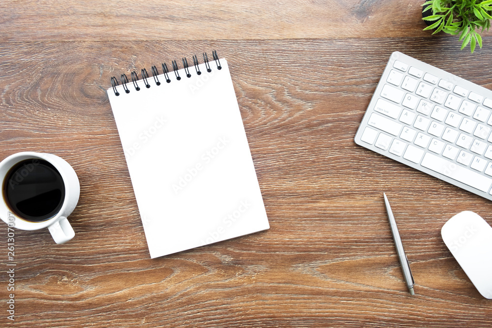 Blank notebook with pen and computer gadgets are on top of wood office desk table. Top view, flat lay. Blank notebook with pen and computer gadgets are on top of wood office desk table. Top view, flat lay.