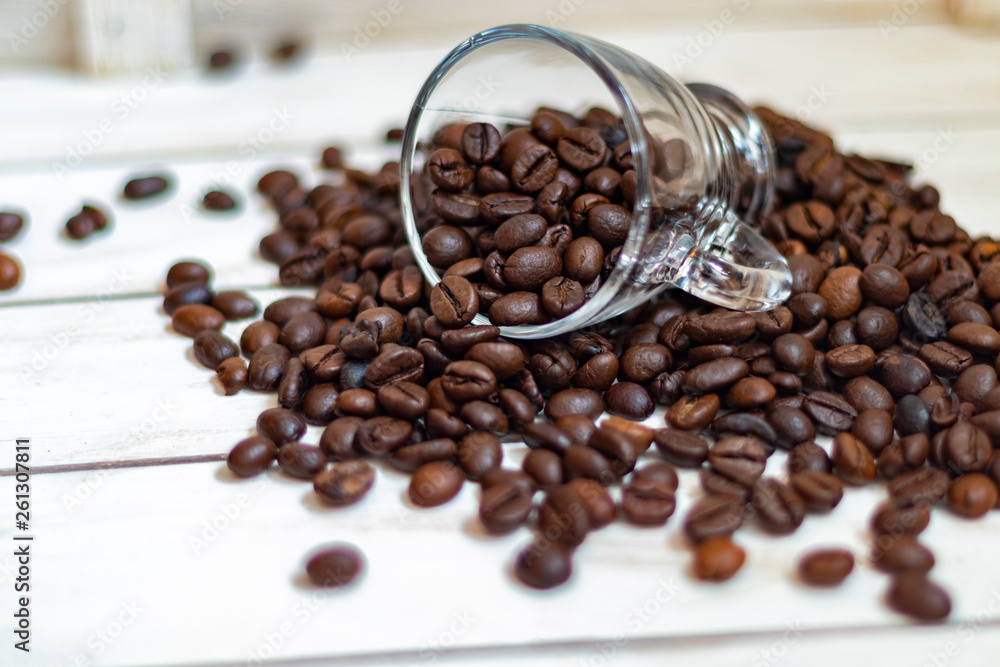 Fototapeta premium Cup and grain of coffee over white wooden background