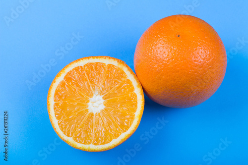 Ripe oranges on blue background