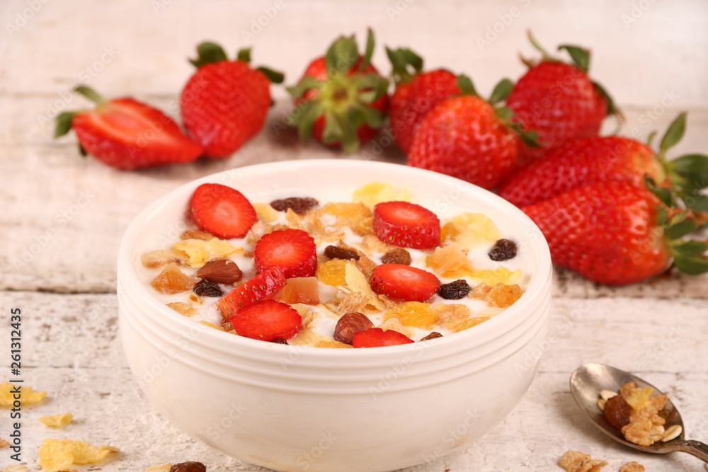 Bowl of yogurt with strawberries and granola muesli, over a white wood background. Bowl of yogurt with strawberries and granola muesli, over a white wood background.
