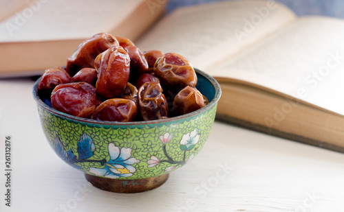 Still life with sweet dried date palm fruits on a vintage piala, ramadan, ramadan, traditional food.