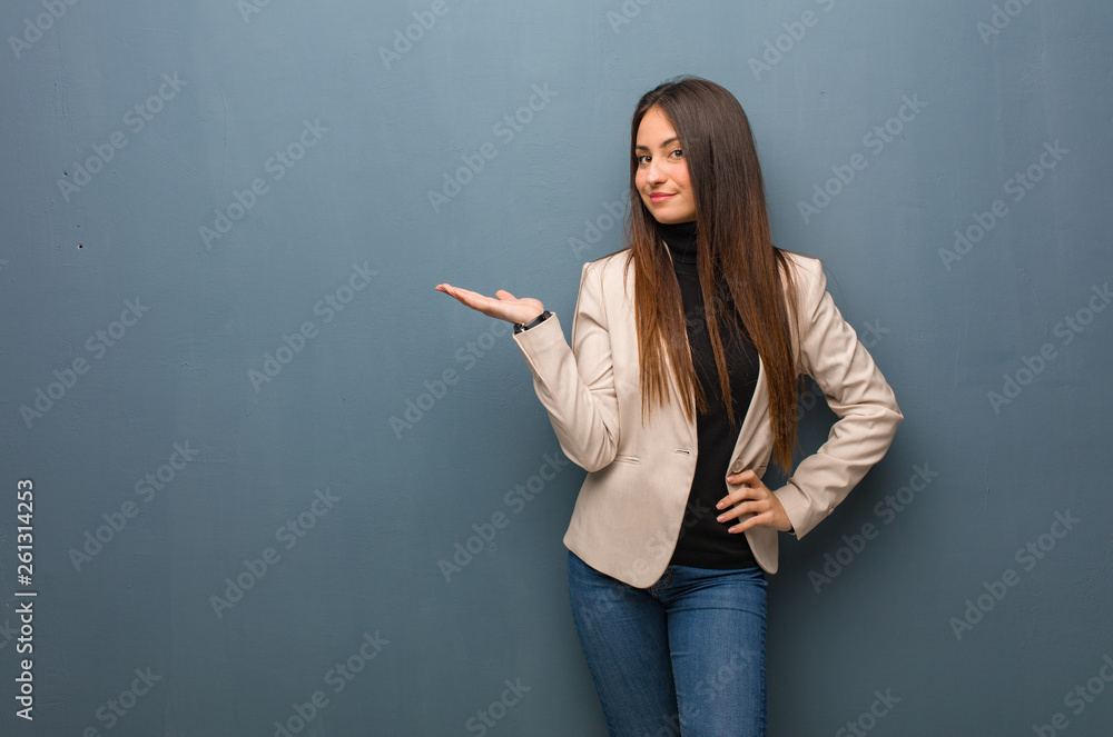 Young business woman holding something with hand Young business woman holding something with hand