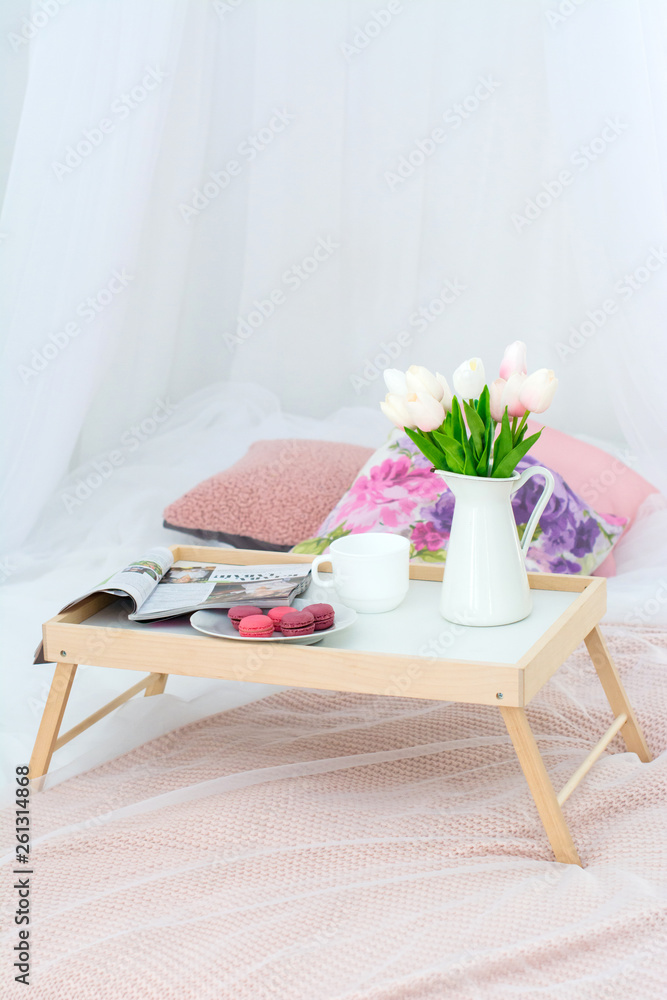 tray with Breakfast and flowers tulips on the bed tray with Breakfast and flowers tulips on the bed