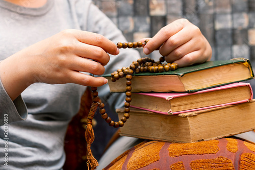 Muslim women using misbaha to keep track of counting in tasbih photo