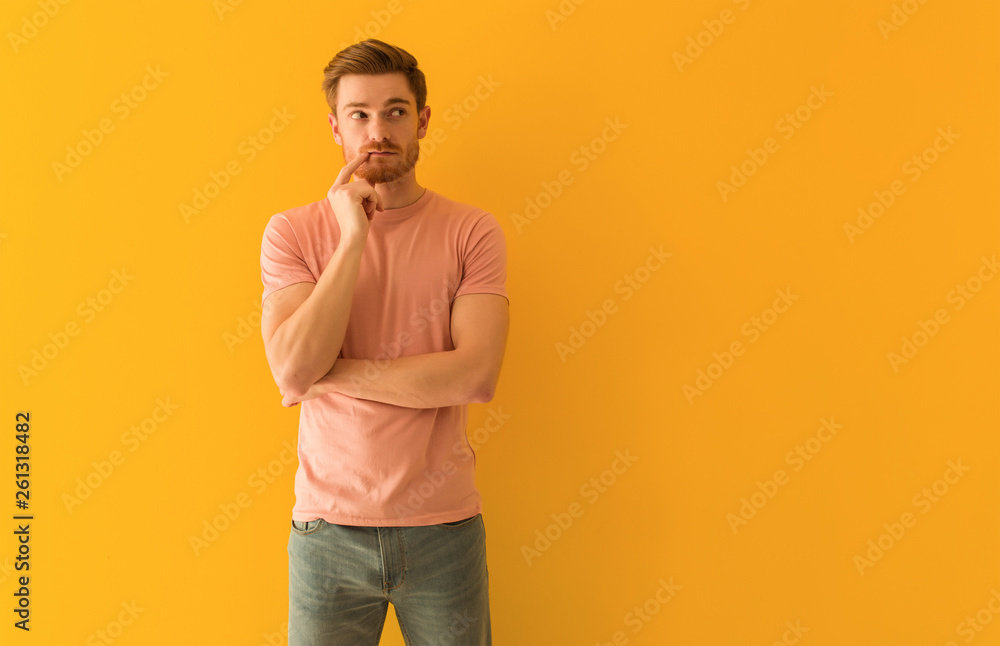 Young redhead man doubting and confused
