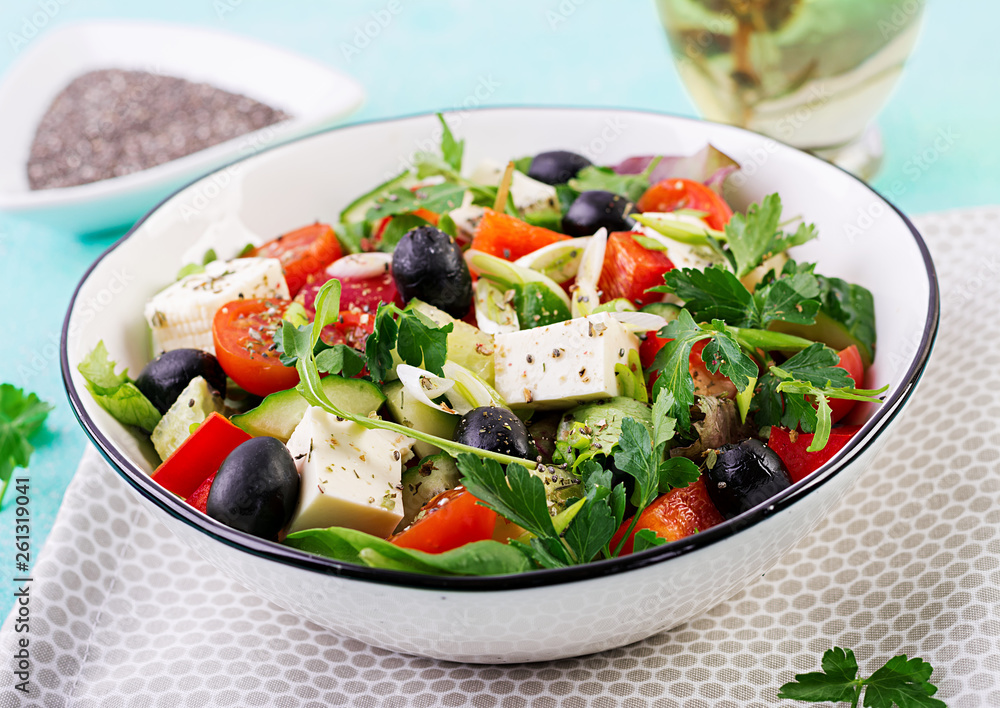 Greek salad with cucumber, tomato, sweet pepper, lettuce, green onion, feta cheese and olives with olive oil. Healthy food. Greek salad with cucumber, tomato, sweet pepper, lettuce, green onion, feta cheese and olives with olive oil. Healthy food.