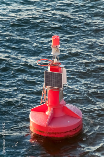 Red Buoy with a Small Solar Panel in the Ocean photo