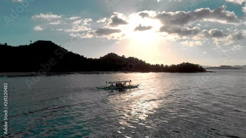 Following Filipino fishing boat by sunset