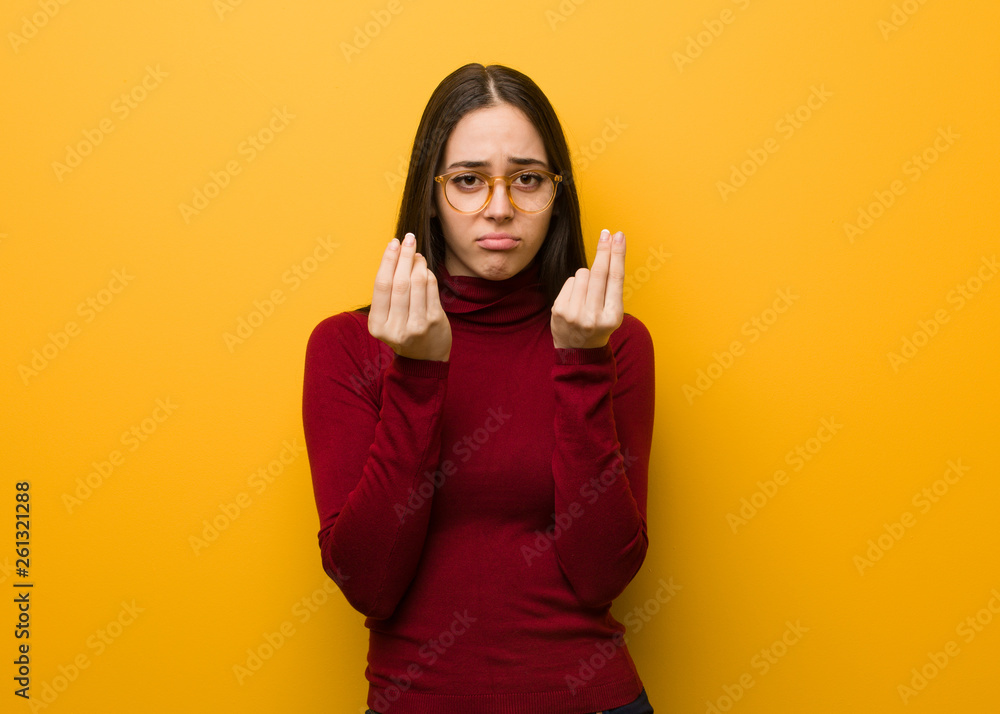 Intellectual young girl doing a gesture of need Intellectual young girl doing a gesture of need