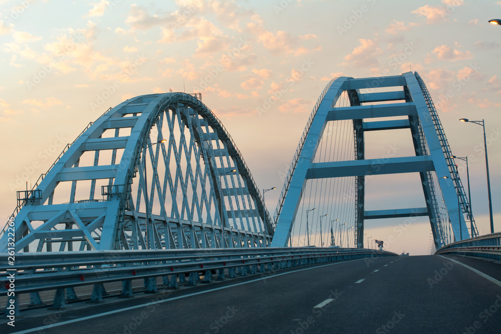 Fototapeta premium Crimean bridge over the black and Azov seas to the city of Kerch at sunset in summer