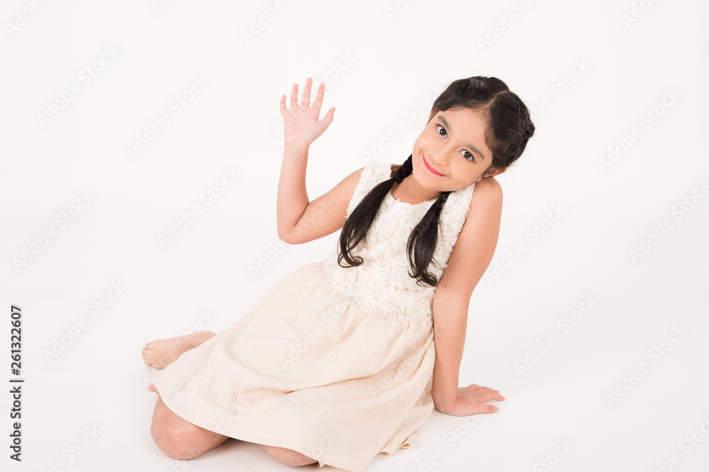 Cute female child sitting on the floor