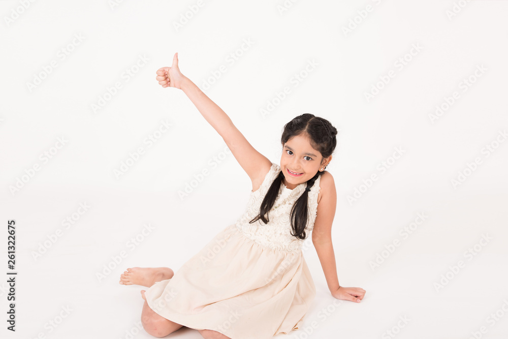 Female child sitting on the floor and indexing Female child sitting on the floor and indexing