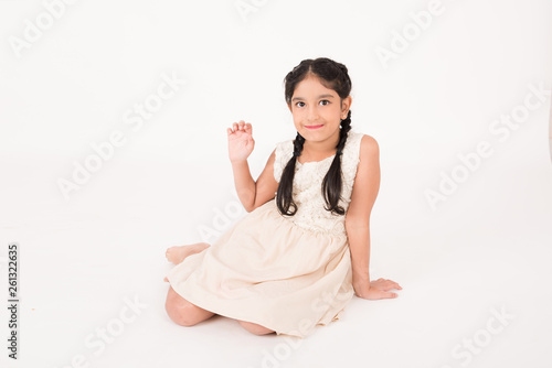 Cute female child sitting on the floor photo