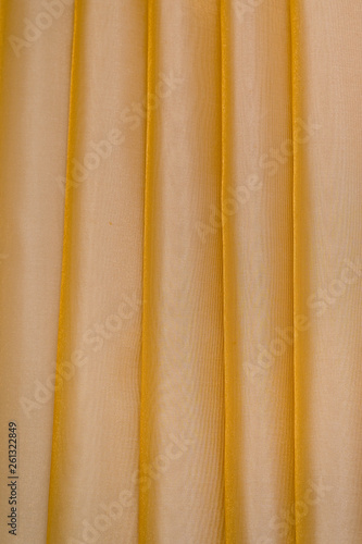 Vertical folds on lightish organza curtains photo