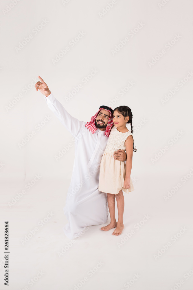 Arab father with his daoghter showing her something Arab father with his daoghter showing her something
