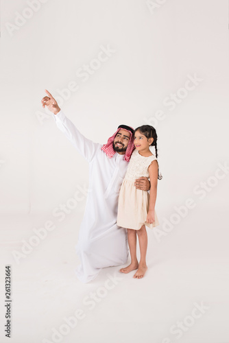 Arab father with his daoghter showing her something