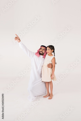 Arab father with his daoghter showing her something