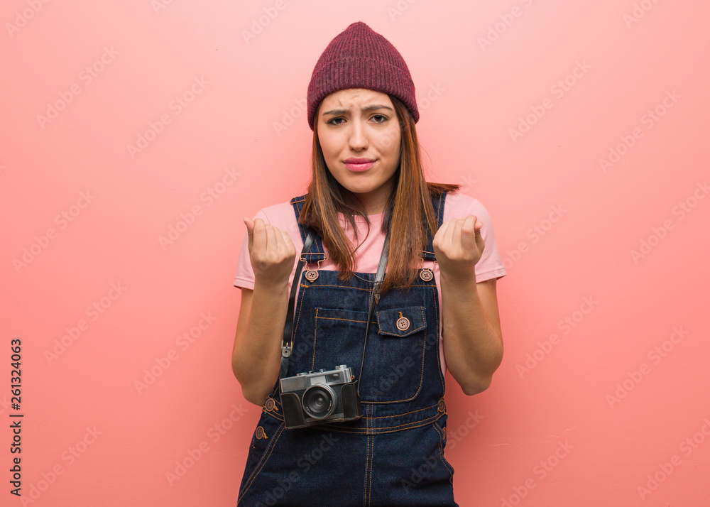 Young cute photographer woman doing a gesture of need