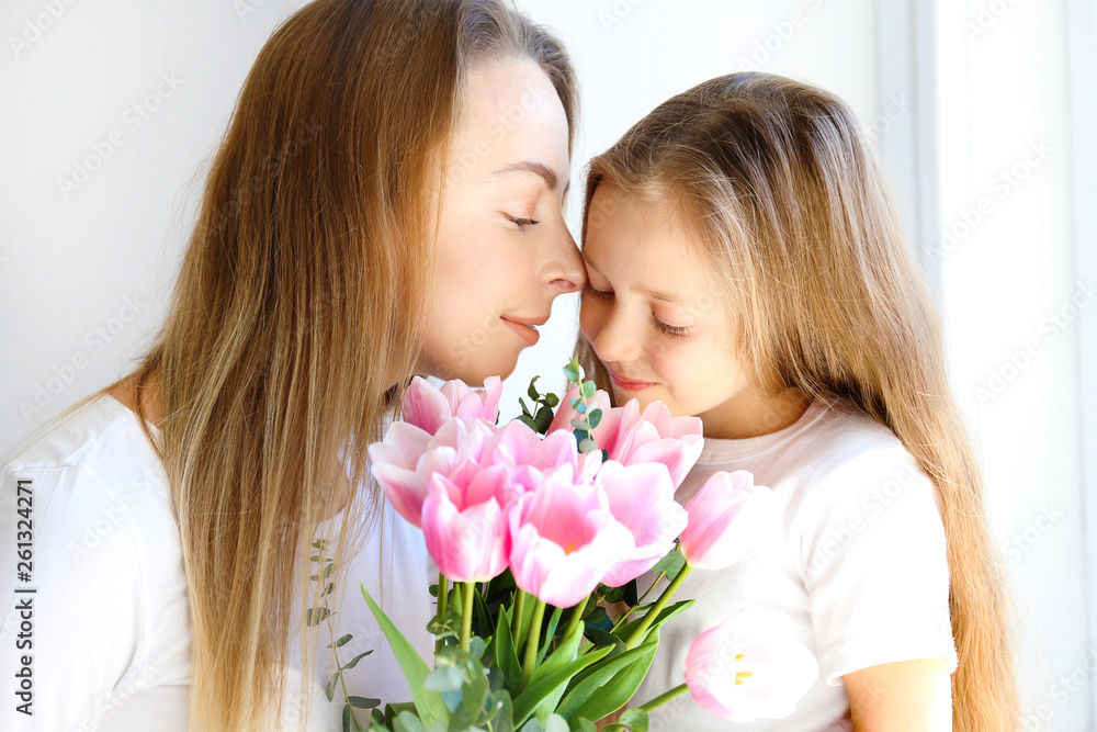 Cute little five year old girl giving her mom a present for mothers day. Adorable scene with daughter surprizing her mum. Close up, background, portrait. Cute little five year old girl giving her mom a present for mothers day. Adorable scene with daughter surprizing her mum. Close up, background, portrait.