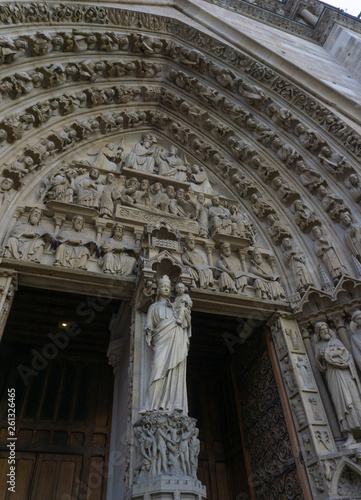 The statue of Virgin Mary on the column between the doors of the Portal of the Virgin, on the main western facade of the Cathedral of Notre Dame de Paris