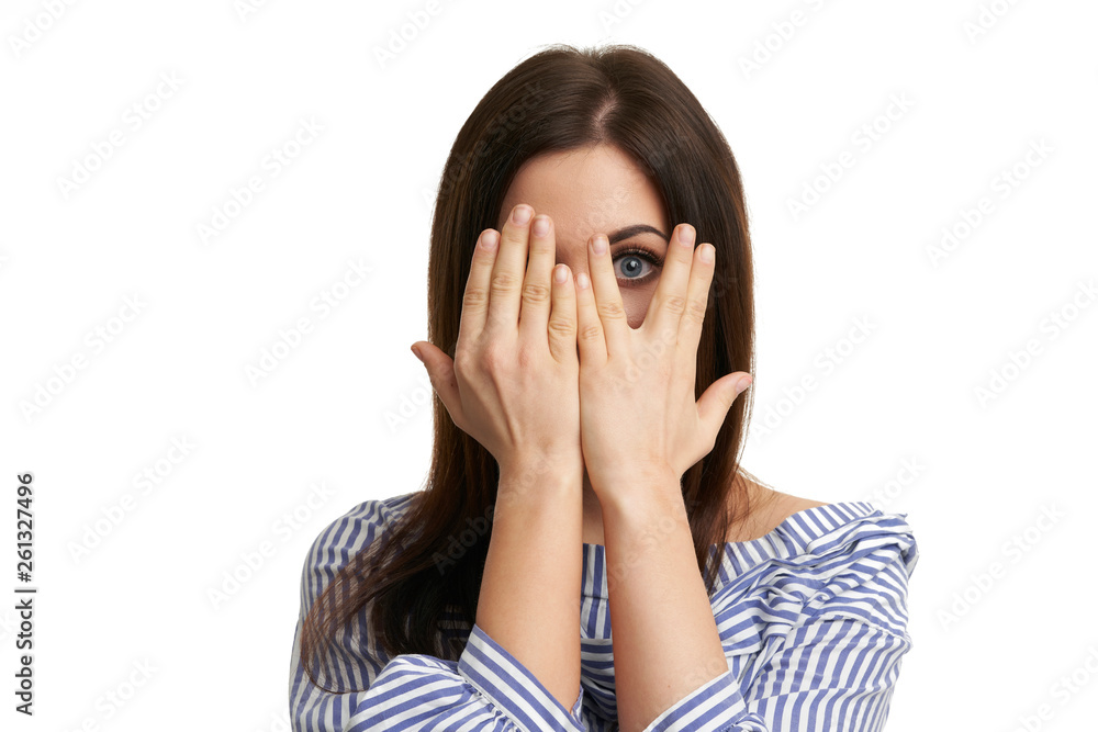 Shocked girl covers her face with hands isolated on white Shocked girl covers her face with hands isolated on white