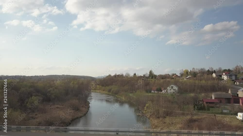 A shallow mountain river flows among stones and lush greenery over the plain. Clear water and beautiful nature for rest and relaxation in the reserve. Fishing in the ecosystem of temperate climate. A shallow mountain river flows among stones and lush greenery over the plain. Clear water and beautiful nature for rest and relaxation in the reserve. Fishing in the ecosystem of temperate climate.