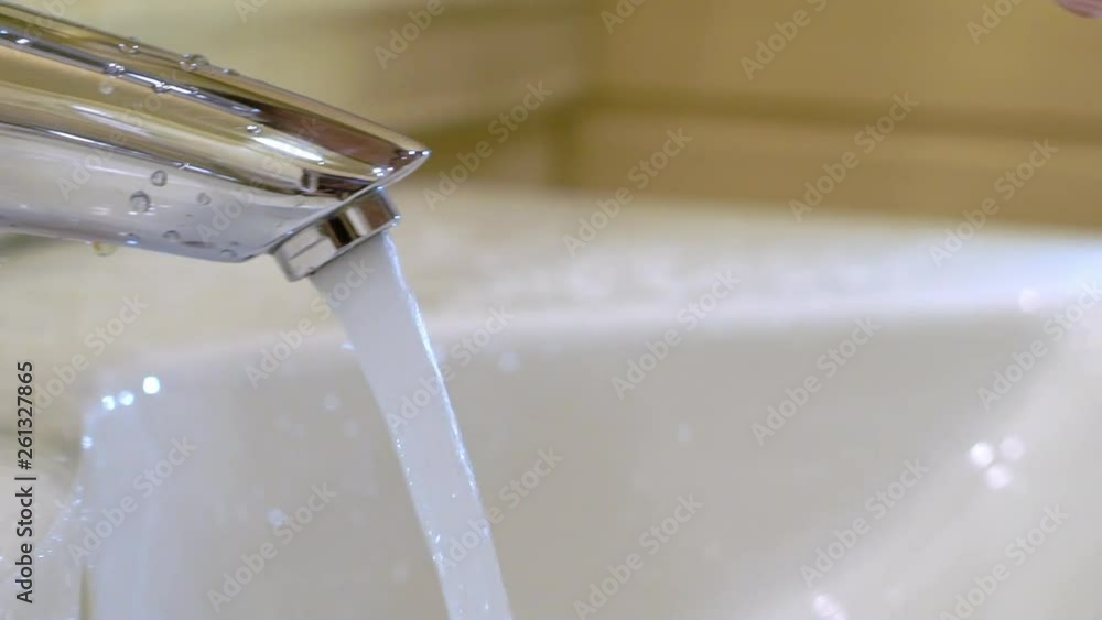 Young man washing hands and face in bathroom at the morning Young man washing hands and face in bathroom at the morning