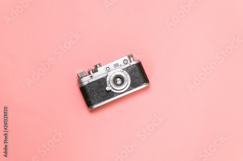 Old rangefinder camera on a pink background Vintage style