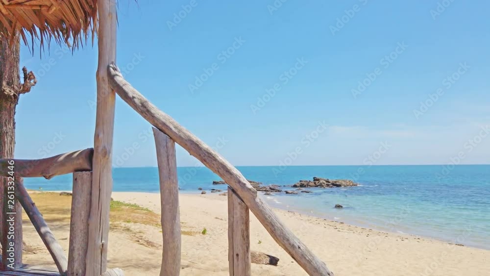 View of sand beach with rocks on tropical island and wooden staircase to bungalow. 4K footage View of sand beach with rocks on tropical island and wooden staircase to bungalow. 4K footage
