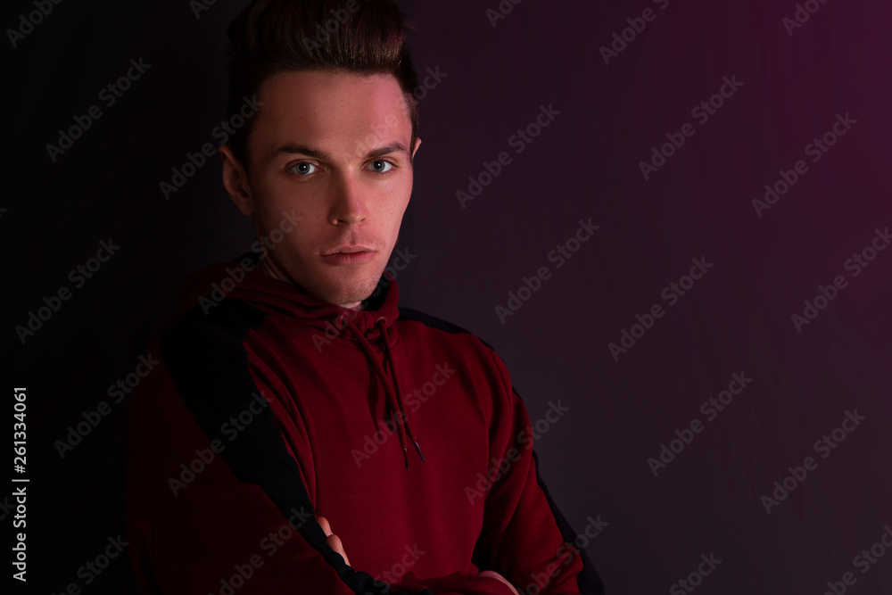 Fototapeta premium Portrait of a guy in a hooded sweater.