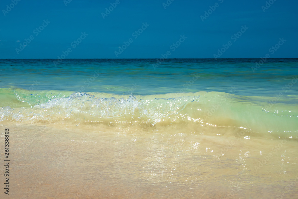 Tropical summer sea wave, sand beach and sky