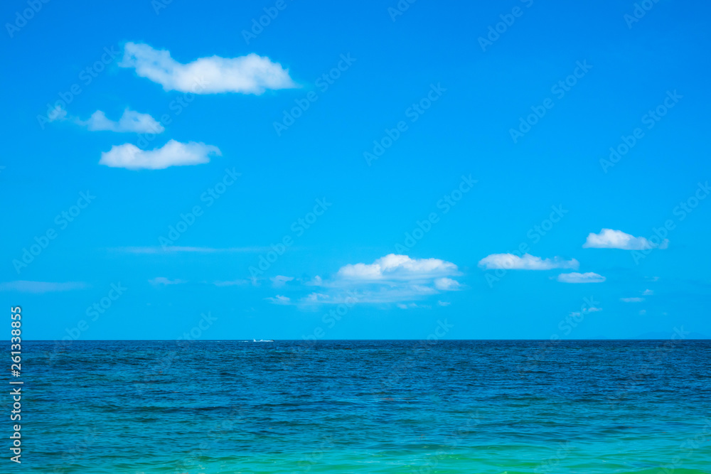 Calm flat surface of sea and cloudless clear blue sky at horizon.