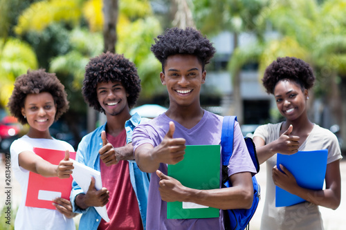 Successful african male student with group of african american students