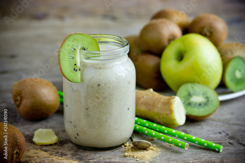 Healthy kiwi apple ginger smoothie in glass jar