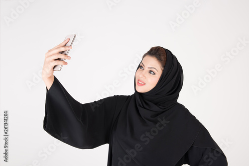 beautiful arab girl taking selfie with her smart phone photo