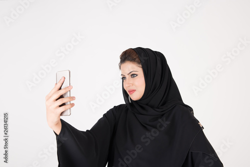 beautiful arab girl taking selfie with her smart phone photo