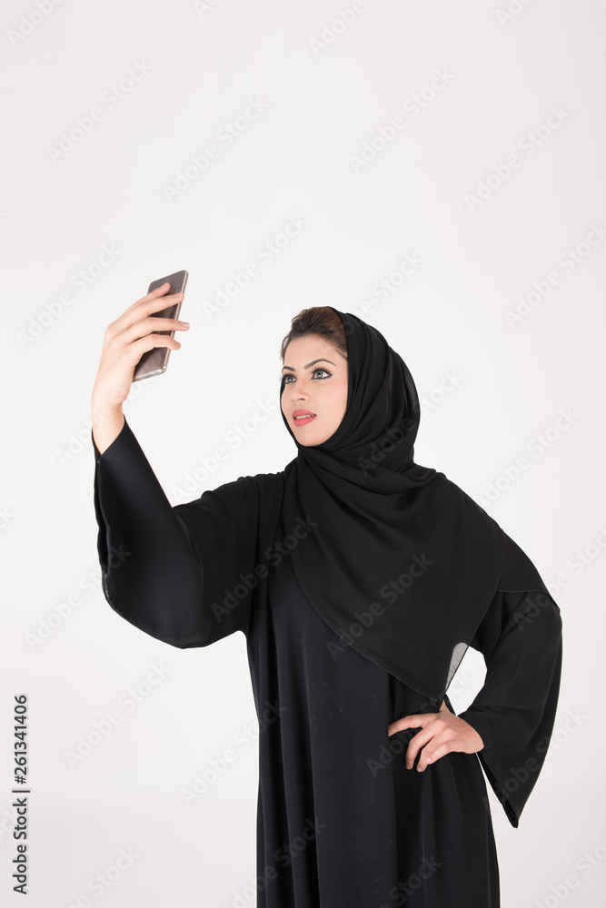 beautiful arab girl taking selfie with her smart phone beautiful arab girl taking selfie with her smart phone