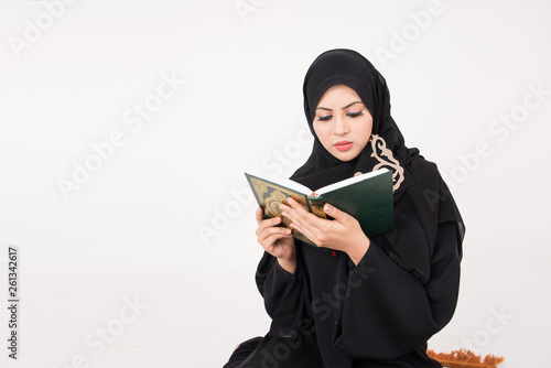Arab muslim woman paraying and reading the holy Quran