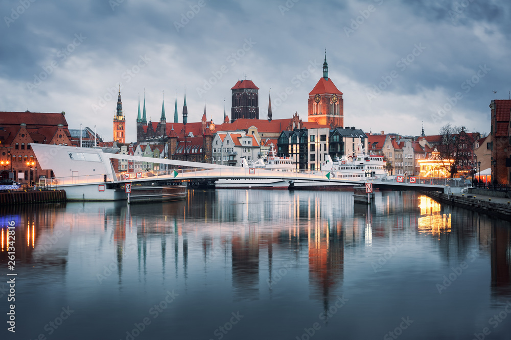 Old town of Gdansk at night. City reflections in Motlava river.