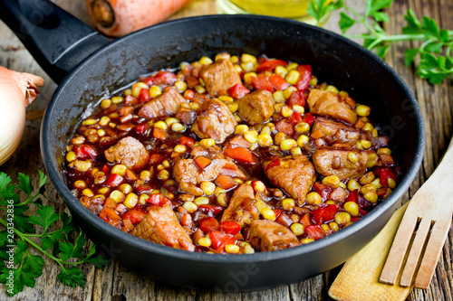 Mexican meat - pork stewed with vegetables corn, pepper, onion, carrot in gravy