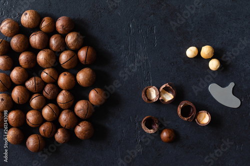 Top view of background texture of fresh natural unshelled raw macadamia nuts, full frame and flat lay