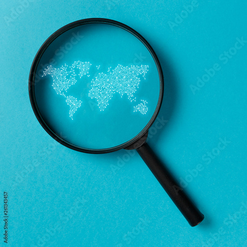 Concept information search. Magnifying glass with international map on blue background. World community and Neural network. New minimal creative concept. Searching information data on internet