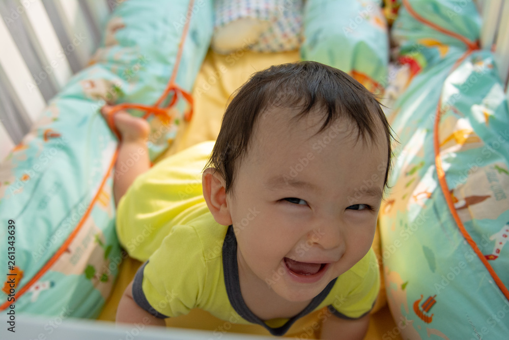 Baby boy playing in the crib funny happy smile Baby boy playing in the crib funny happy smile