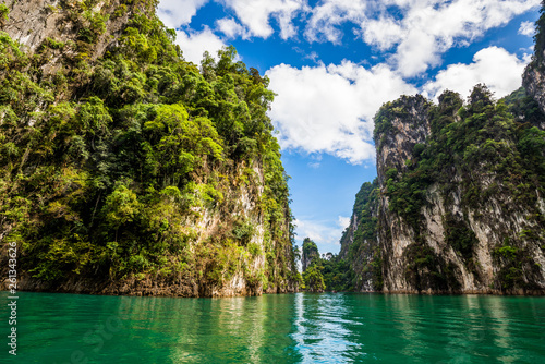 Beautiful nature rock mountains cliff and blue emerald water color lake river with blue clear sky in Ratchaprapa Dam at Khao Sok National Park, Surat Thani Province, Thailand. Asia tourism location.