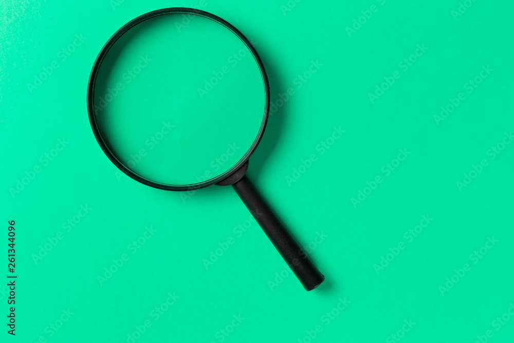 Magnifying glass on Mint background. Top view. Flat lay. Copy space. Minimal creative concept. Search concept. Neo Mint color of the year 2020 Magnifying glass on Mint background. Top view. Flat lay. Copy space. Minimal creative concept. Search concept. Neo Mint color of the year 2020