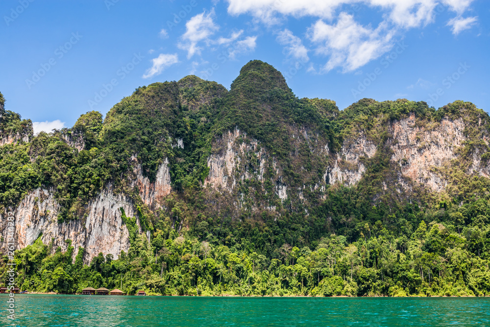 Resort on foothill near lake. Beautiful nature rock mountains cliff and blue water color lake river in Ratchaprapa Dam at Khao Sok National Park, Surat Thani, Thailand. Asia tourism location. Resort on foothill near lake. Beautiful nature rock mountains cliff and blue water color lake river in Ratchaprapa Dam at Khao Sok National Park, Surat Thani, Thailand. Asia tourism location.