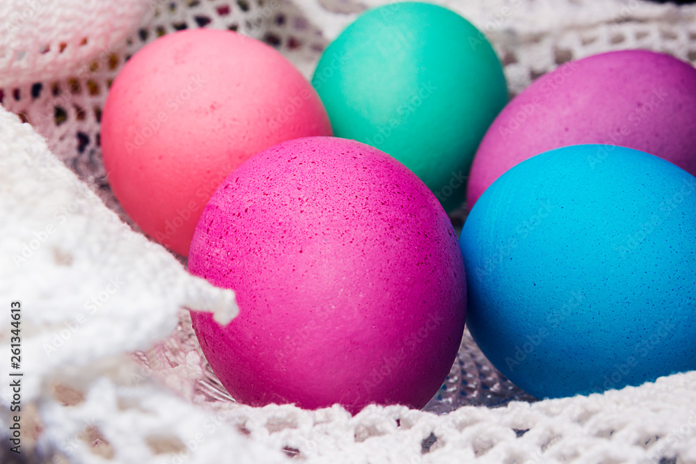 Colored Easter eggs on a white lace napkin Colored Easter eggs on a white lace napkin