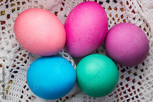 Colored Easter eggs on a white lace napkin