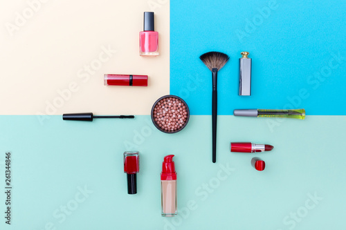 Decorative cosmetics, makeup products and brushes on pastel blue color background