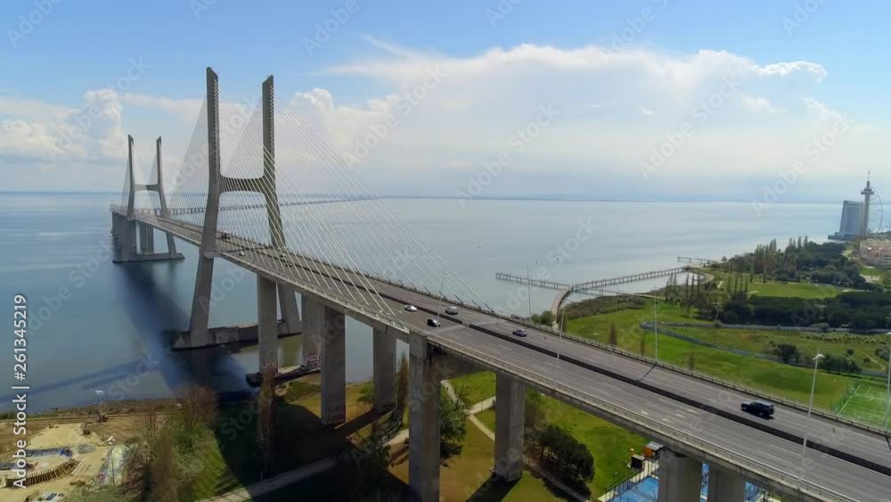 Aerial, rising, drone shot, over the Vasco da Gama bridge and road A12, full of traffic, on Tejo river, in Lisbon, Portugal Aerial, rising, drone shot, over the Vasco da Gama bridge and road A12, full of traffic, on Tejo river, in Lisbon, Portugal